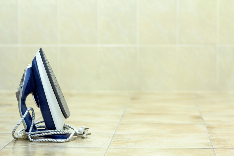 Reattach Floor Tiles With An Iron and Aluminum Foil | Alamy Stock Photo