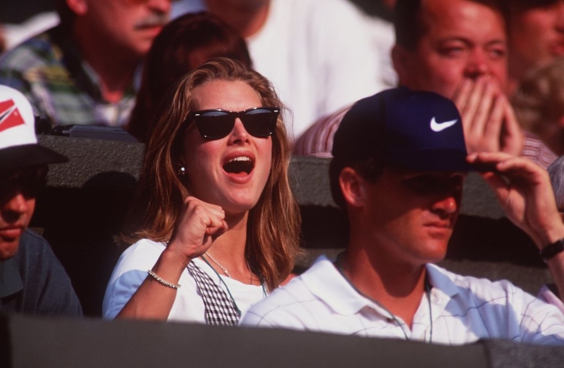Brooke Shields Cheering on Andre Agassi | Getty Images Photo by Clive Brunskill/ALLSPORT