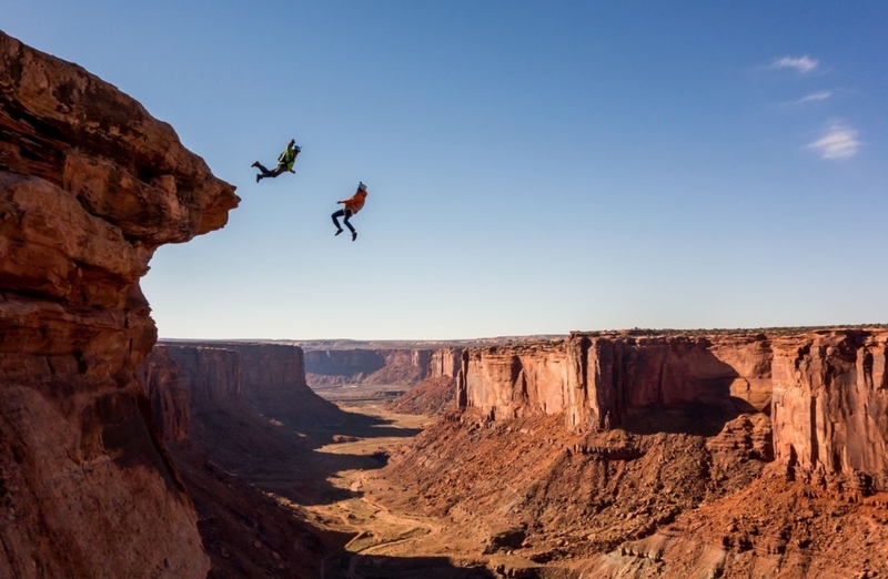 Jump very high. Base Jump. Moab Space. Jumper in USA.